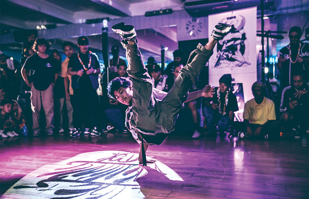 a person doing a hand flip on a stage