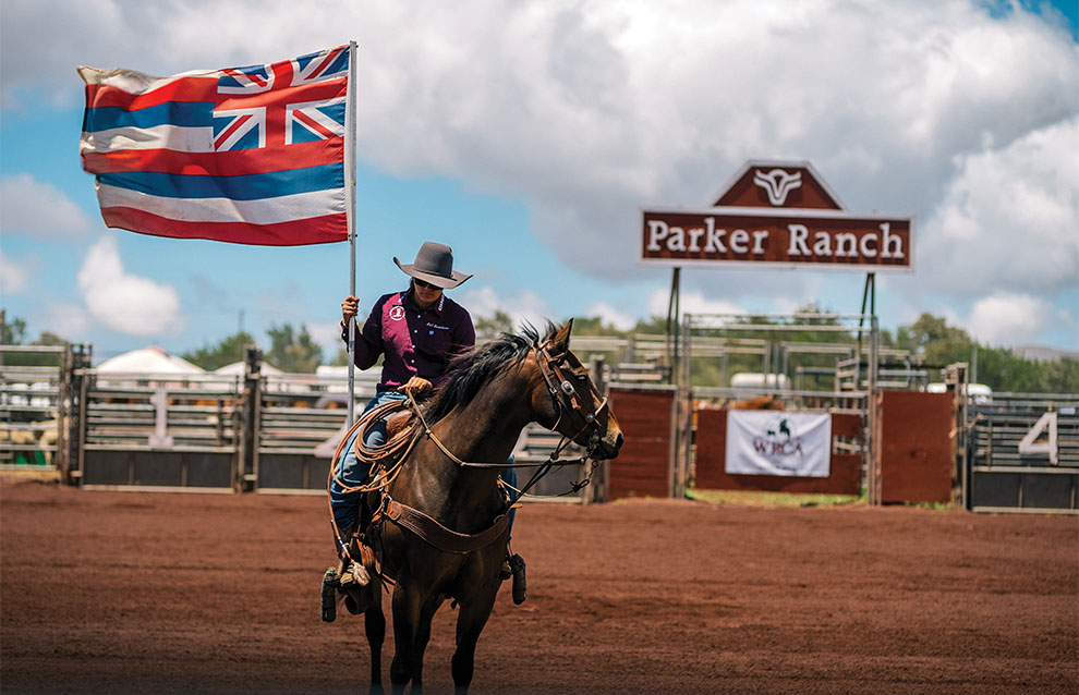 professional cowboy riding horse with flag at Parker Ranch. 