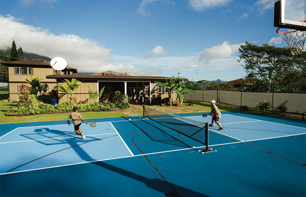 two pickleball players on a blue court in Hawaii