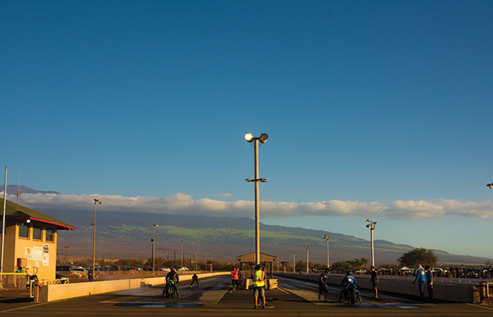 race track in Hawaii with a man in neon vest standing between two lanes in the center.