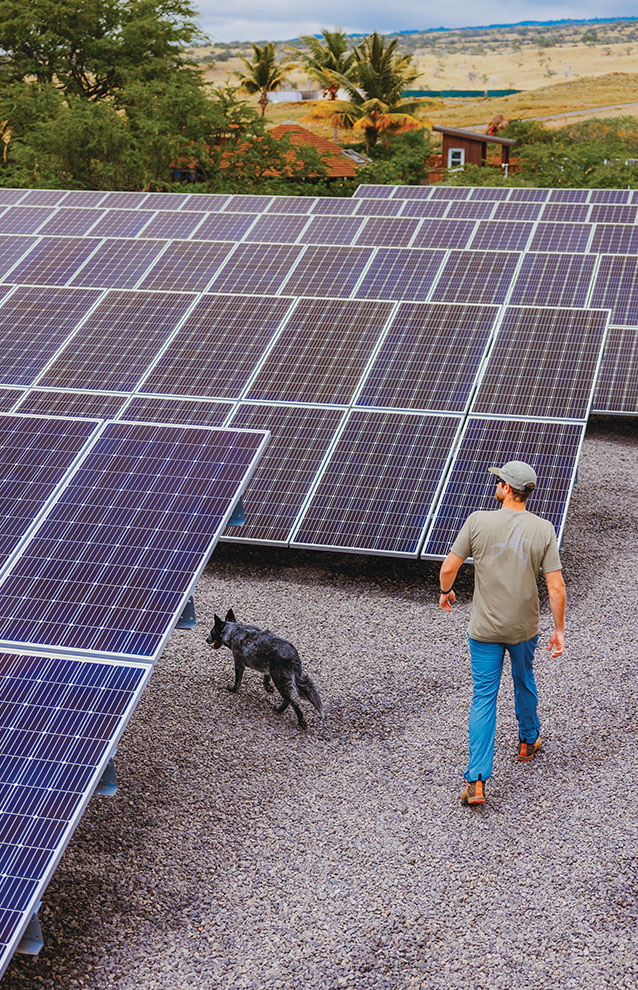 a person walking next to solar panels