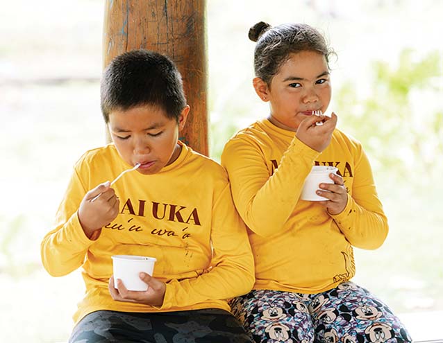 a child and child eating yogurt