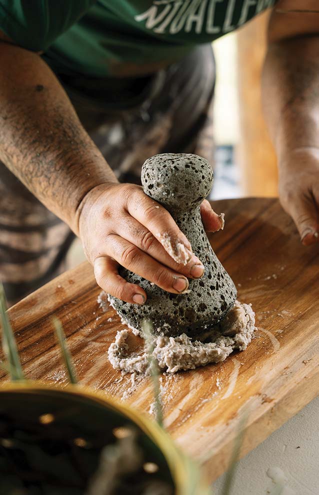 a person using a stone to grind something