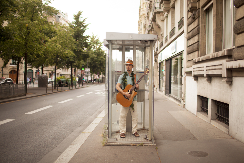 A musician in the Festival des Arts d'Hawai'i in a telephone booth